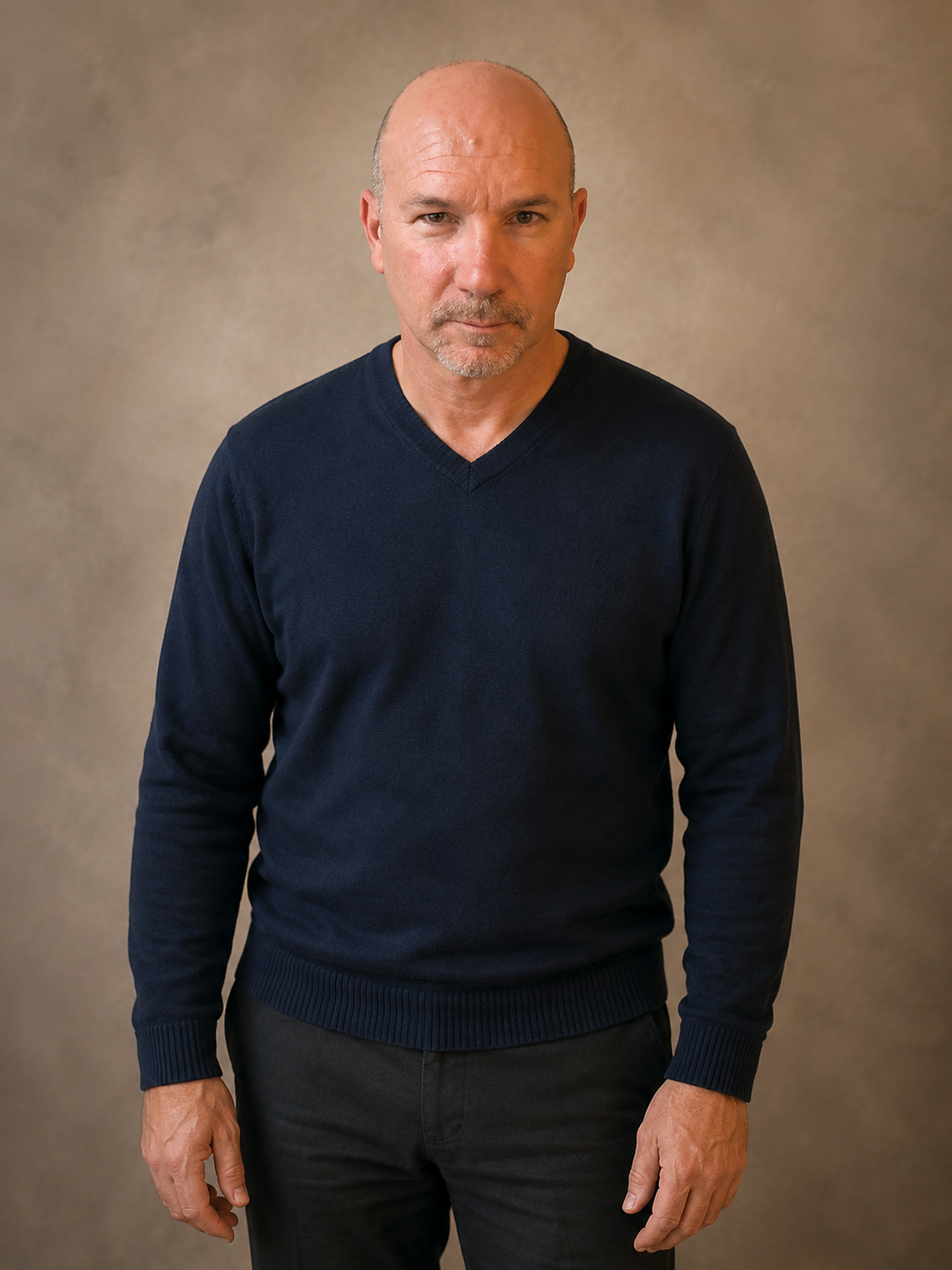 Andre Plessis standing in a navy sweater